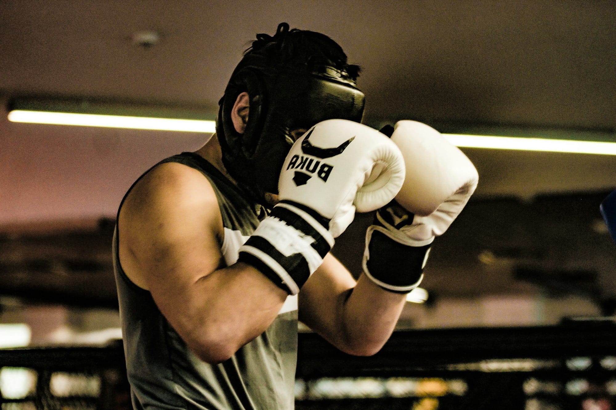 a man wearing a white and black boxing glove